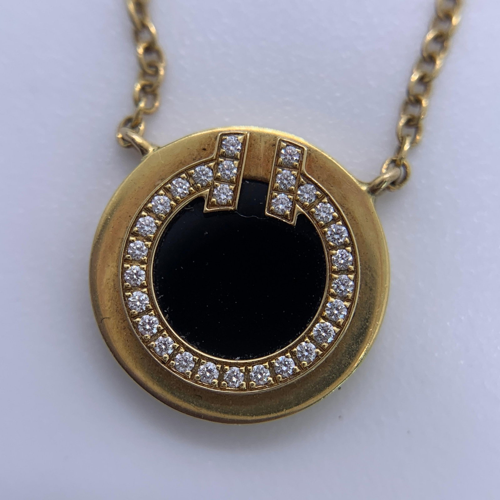 Tiffany 18K Yellow Gold Black Onyx & Diamond T Two Circle Pendant Necklace: A sleek and graphic statement of modern luxury, this Tiffany & Co. Tiffany T Two Circle Pendant Necklace balances bold geometry with timeless elegance. Centered around the iconic, stylized graphic of 