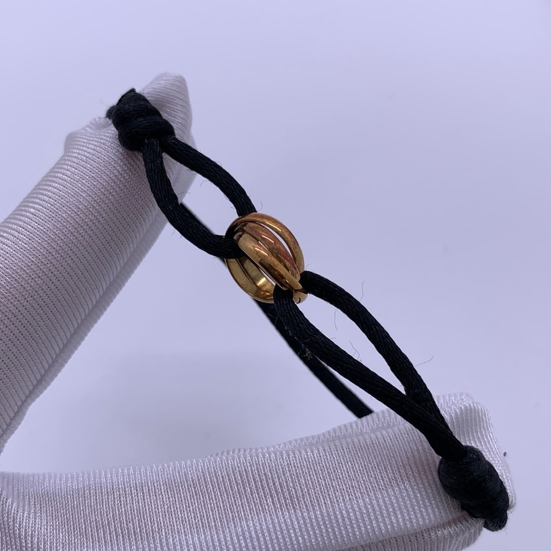 Cartier Trinity 18K Yellow Gold Three-Ring Black Bracelet: Condition: Normal signs of use,surface scratchesAccessories: CertificationSize: Gram Weigh:3.1gDesigner: CartierMaterial: 18K Gold"