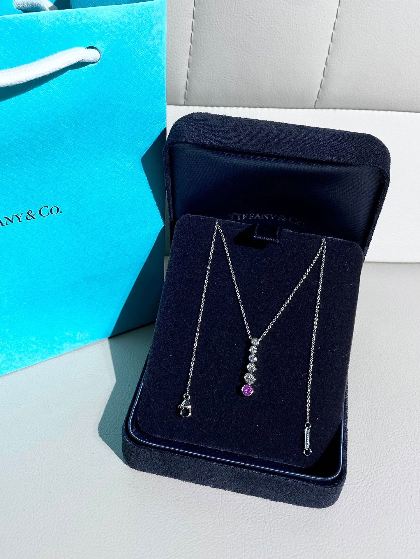 Tiffany Jazz graduated drop pendant pink sapphire diamonds Platinum necklace: Tiffany & Co. Jazz graduated drop pendant necklace, featuring a combination of diamonds and a pink sapphire.Key SpecificationsCollection: Tiffany & Co. Jazz.Material: Crafted in PT950 Platinum.Gemston