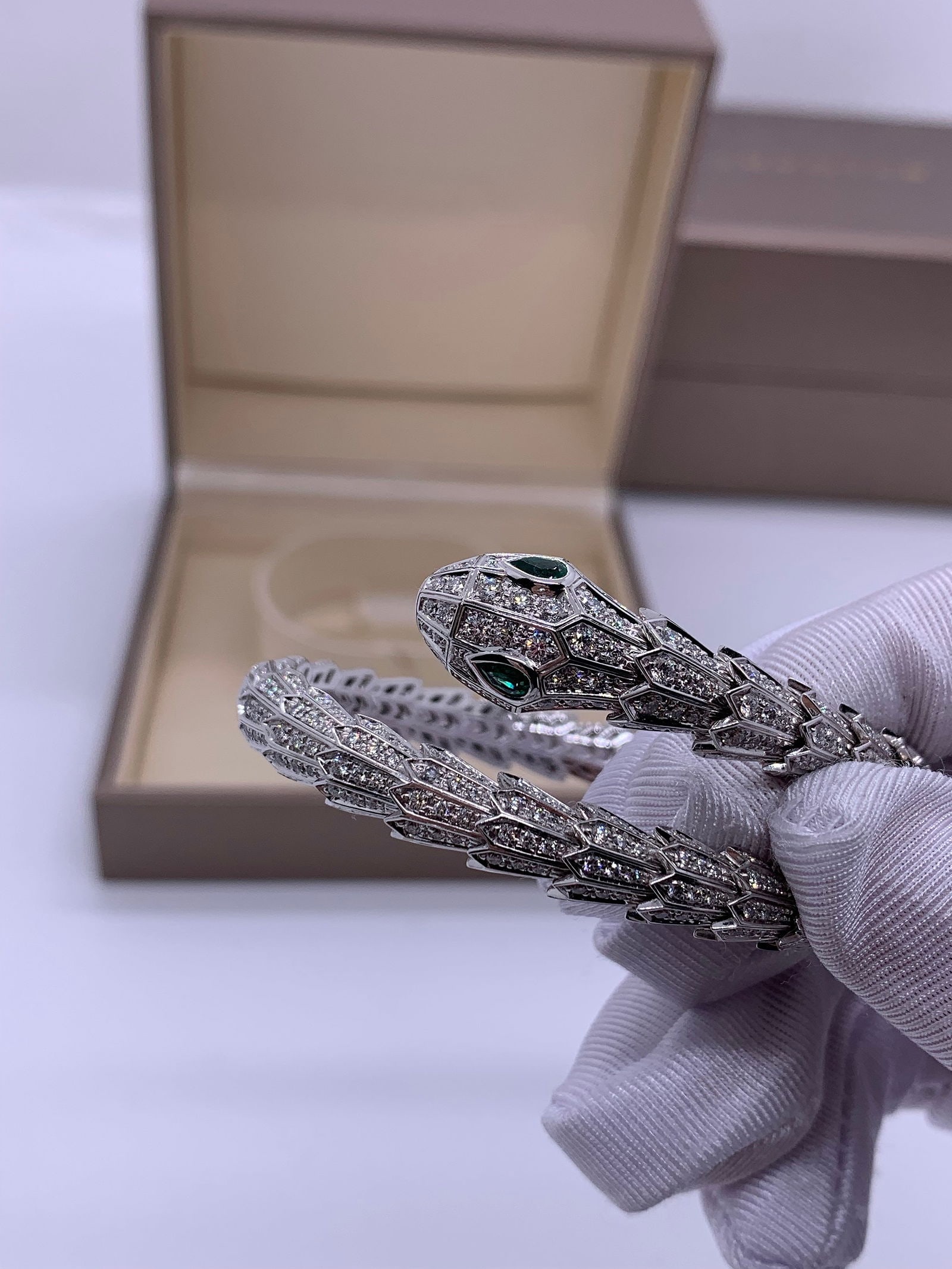 BVLGARI Serpenti White Gold Full Diamond Emerald-Eyed Snake Bracelet: Iconic BVLGARI Serpenti Bracelet in 18K white gold, fully set with pave diamonds and enhanced by vivid emerald eyes. Size M. Original retail price ??661,000. Complete with box and certificate. A timel
