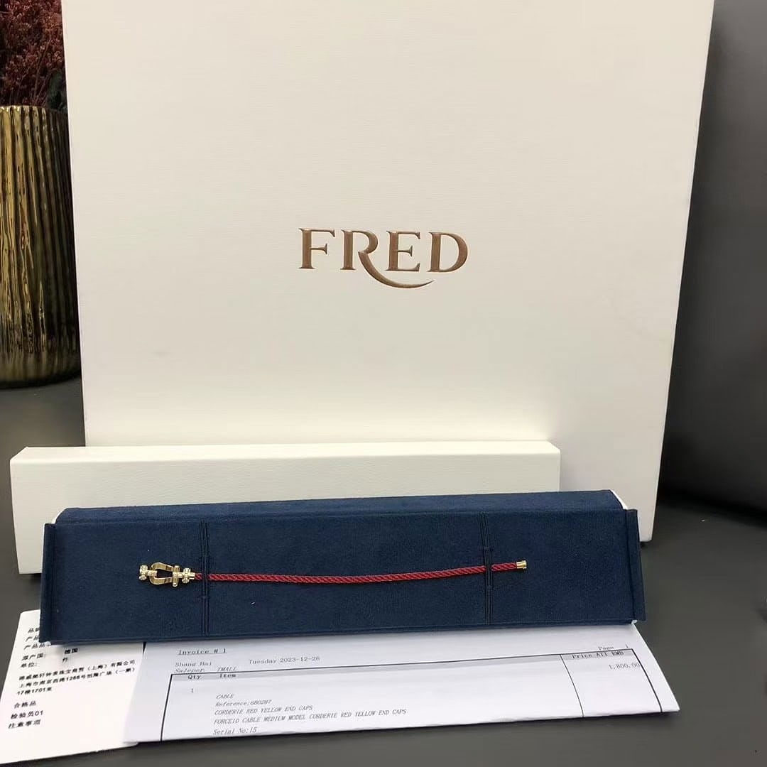 FRED Force 10 Diamonds 18k Yellow Gold Red Woven Cable Medium Bracelet Size 15: FRED Force 10 model, specifically a medium model featuring an 18k yellow gold buckle set with diamonds on a red woven cable.Key FeaturesDesign: One of the Maison's signature pieces, originally created