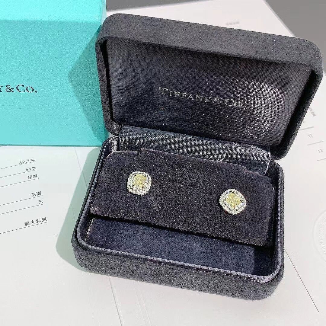 Tiffany & Co. Soleste Yellow Diamond Earrings Platinum: Design: Cushion-cut yellow diamonds set in Platinum claws to enhance their natural color.Halo: A double row of round brilliant-cut white diamonds set in Platinum.