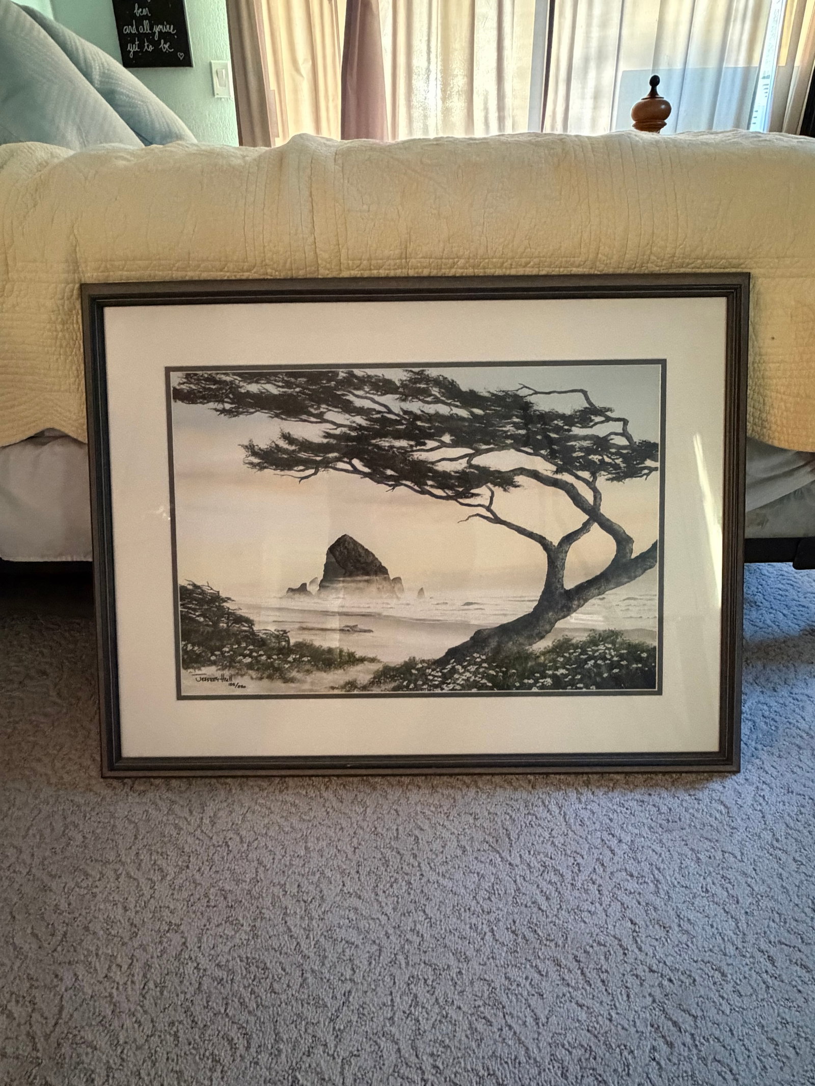 Jeffery Hull Print: 125/250 H 25" W 34"Framed limited edition coastal landscape print by listed Oregon artist Jeffrey Hull. Depicts Haystack Rock off Cannon Beach, Oregon with windswept coastal tree and floral foreground