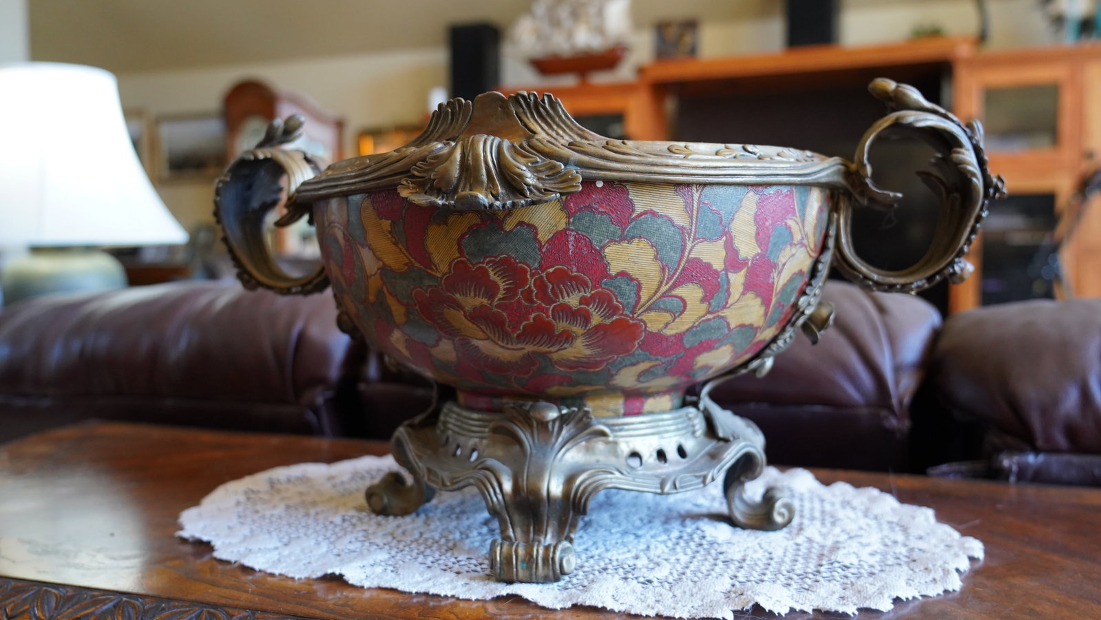 Castilian Decorative Porcelain Jardinière / Centerpiece Bowl with Ornate Metal Mounts: Large decorative porcelain centerpiece bowl by Castilian featuring a vibrant floral motif in red, gold, and green tones. Set within an ornate antiqued metal frame with elaborate scroll handles, foliat