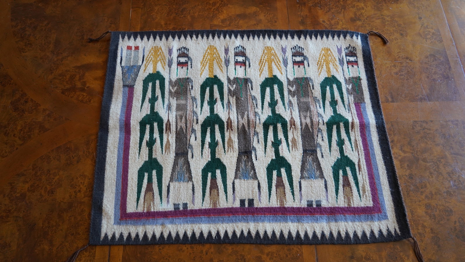 Vintage Navajo Style Yei Rug / Wall Hanging: Handwoven wool textile featuring traditional Yei (Holy People) figures and corn stalk motifs in a classic Southwestern/Native American design. Rectangular format with tassel corners and geometric bord