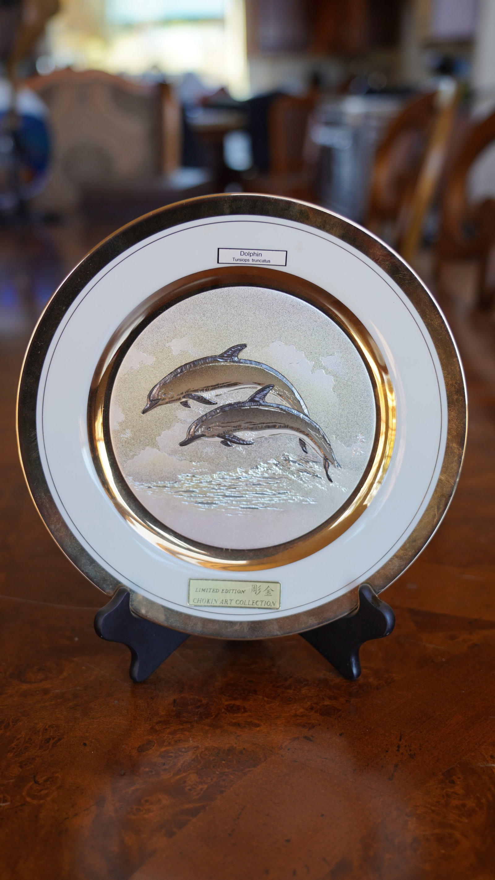 Chokin Art Collection Dolphin Plate Limited Edition Decorative Wall Plate: Decorative limited-edition plate from the Chokin Art Collection featuring two dolphins in motion over a textured ocean background. Design incorporates metallic detailing using the traditional