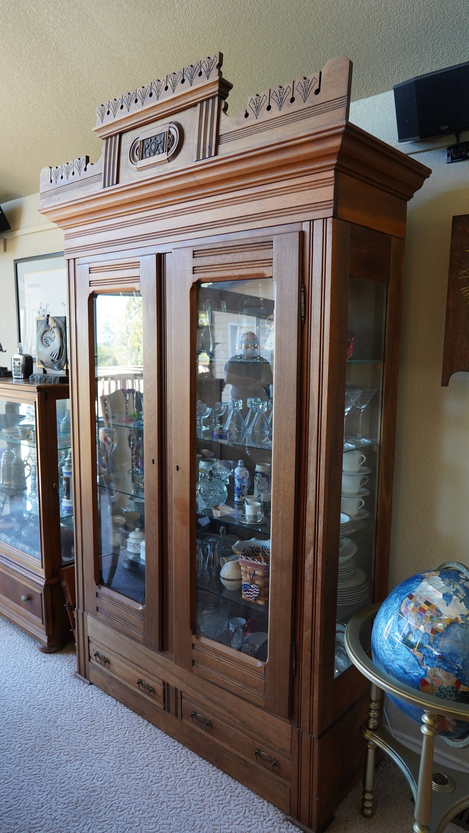 19th Century French Hutch: This 19th Century French Hutch is a beautiful antique piece filled with timeless character and classic European charm. Featuring four glass display shelves behind two doors this hutch offers an elegan