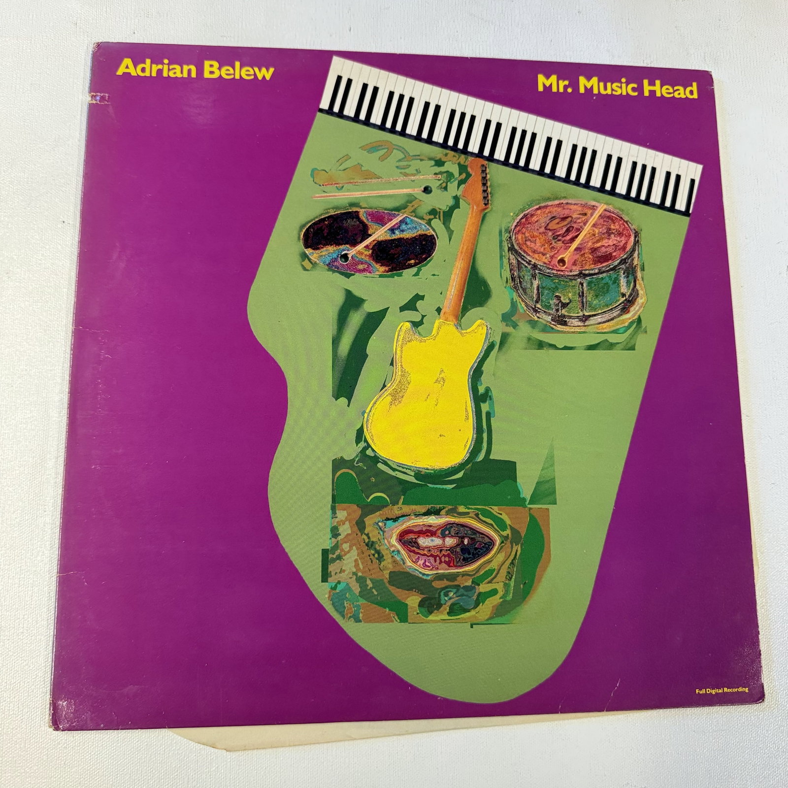 Vinyl Record Adrian Belew: Overall good - Vinyl: good - Cover: good - has been cleaned - Ships in a standard LP box with plastic sleeve - Combined shipping: y