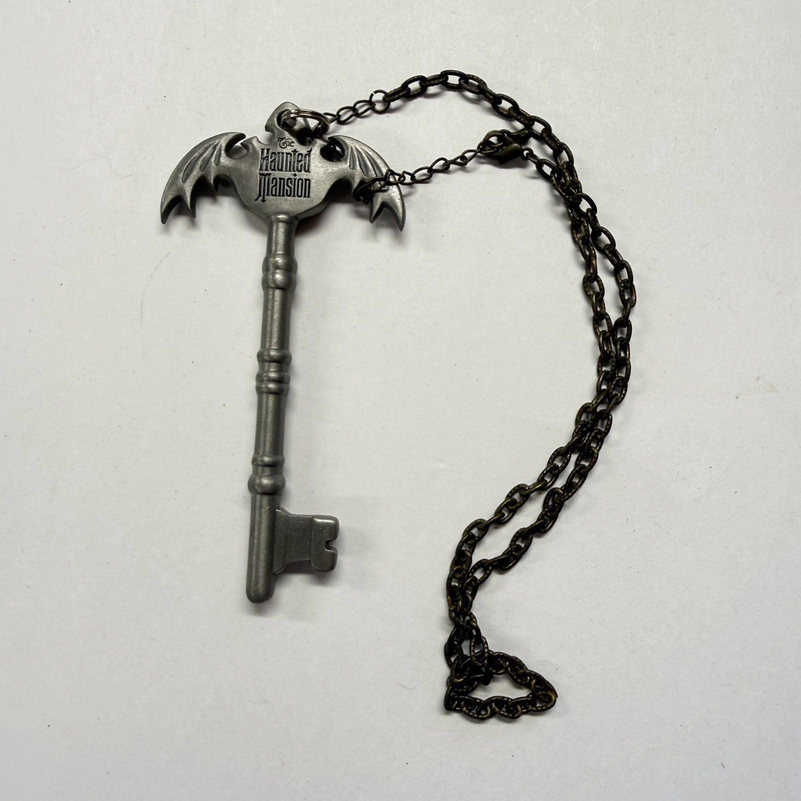 Disney Haunted Mansion Bat Wing Key Necklace: Cleaned for good measure - ships in an LP box with plastic sleeve - Combined shipping offered.