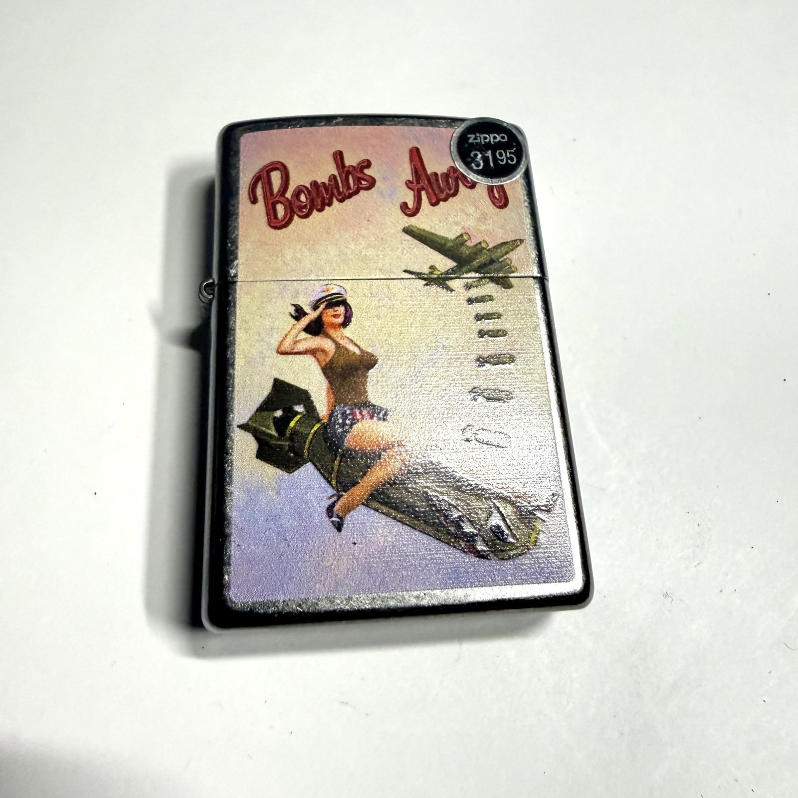 Zippo Lighter: Unfired Bombs Away Pinup Girl: Combined shipping offered.