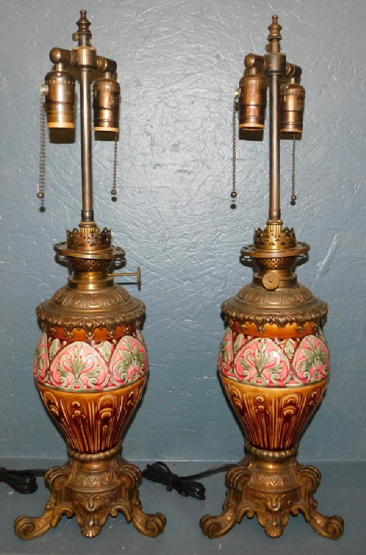 Pair of Majolica oil lamps converted to electric.: Pair of Majolica oil lamps converted to electric. 26" tall.