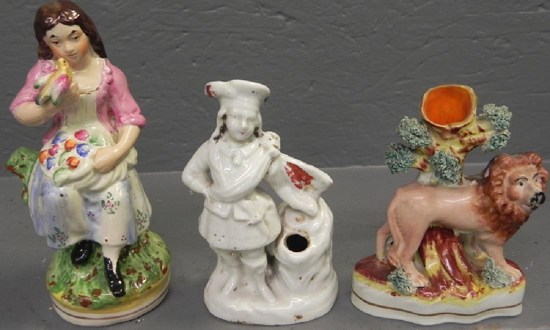 Staffordshire lion, Girl w bird, & Robin Hood figures. (1 of 3)