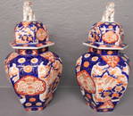 Pair of 19th C Imari covered urns w Foo dog finials