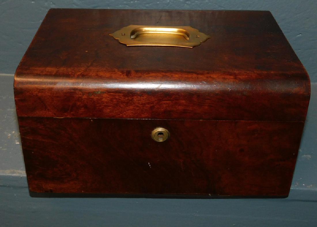 Figural mahogany dresser box with brass handle. (1 of 2)