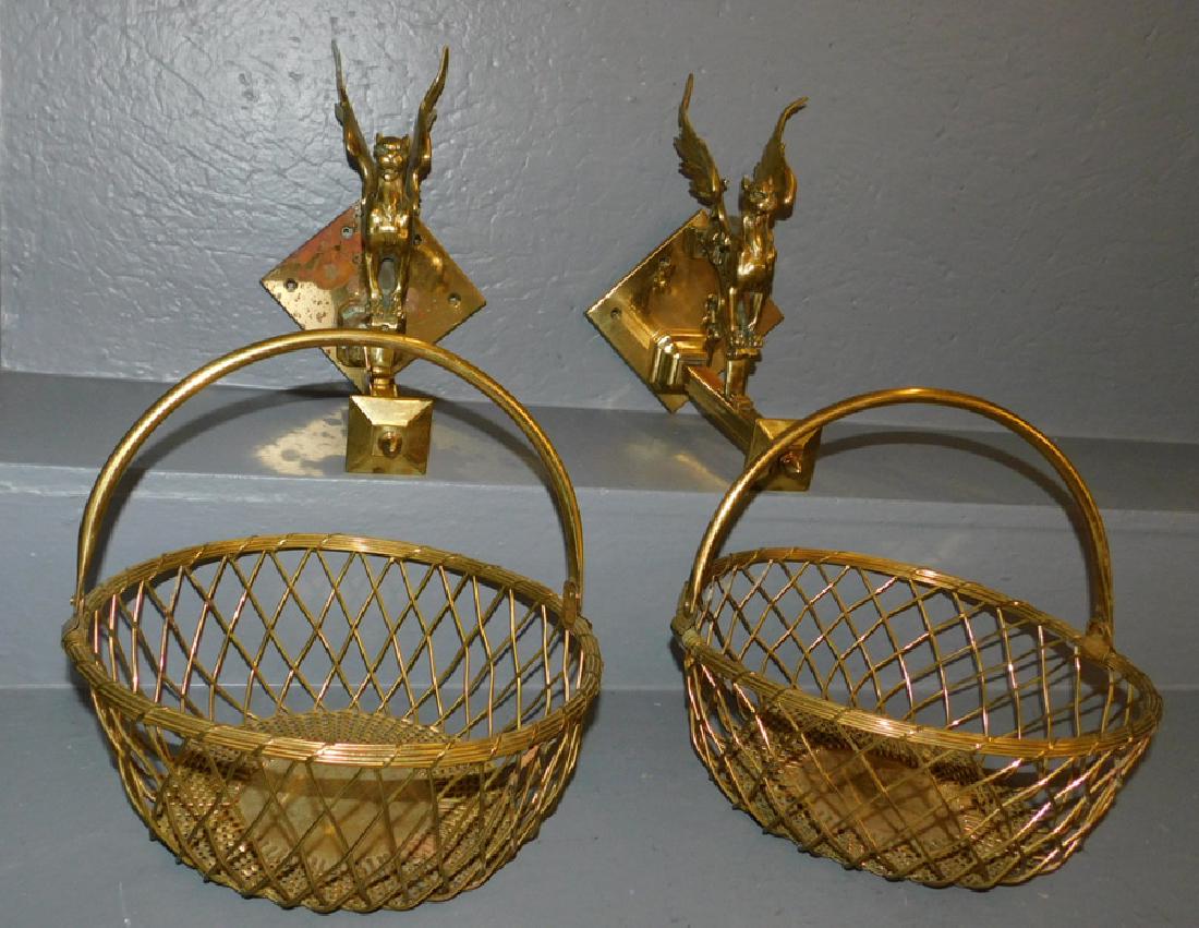 Pr gryphon brass wall brackets w/ hanging baskets.: Pair of gryphon brass wall brackets with hanging baskets. 10" long x 12" deep.
