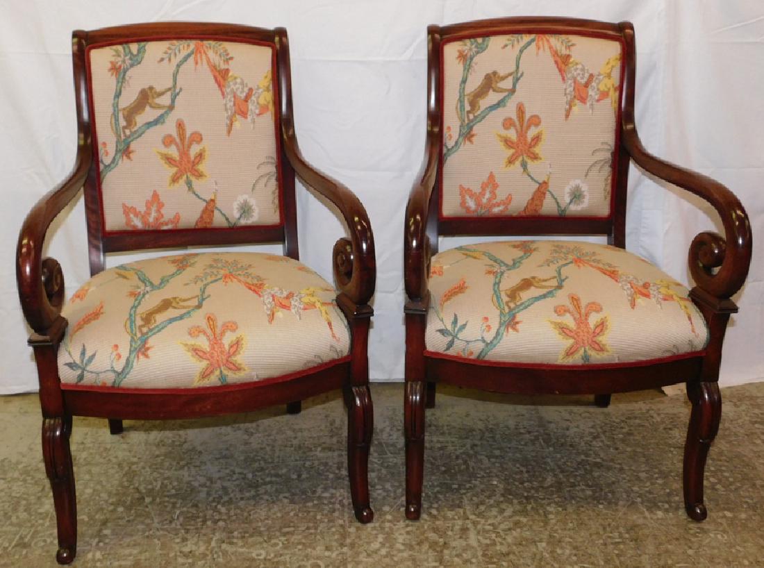 Pair of mahogany Duncan Phyfe style arm chairs: Pair of mahogany Duncan Phyfe style arm chairs with needlepoint upholstery. 35" tall.