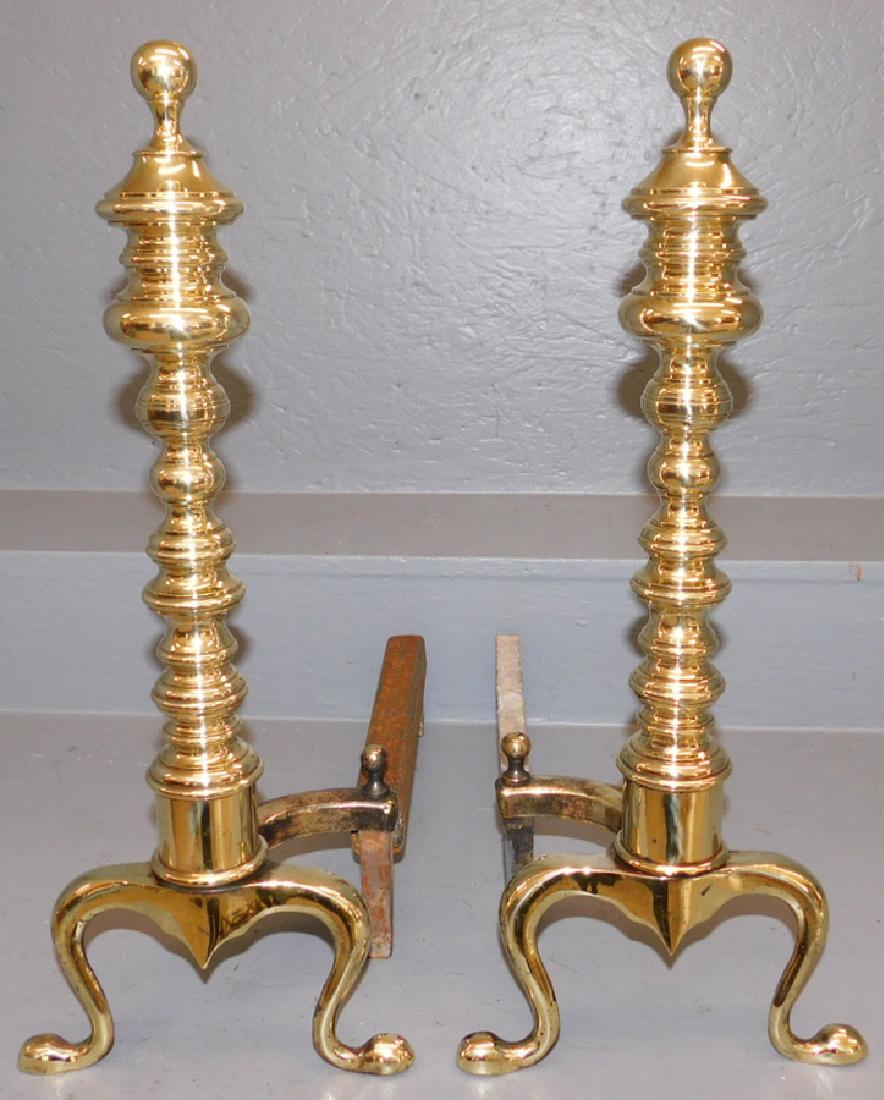 Pair of polished brass andirons.: Pair of polished brass andirons. 20" tall.