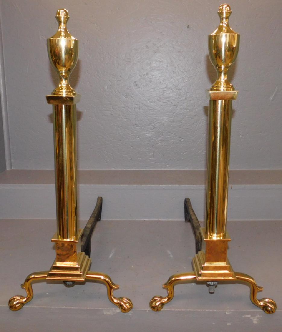 Pair of claw foot polished brass andirons.: Pair of claw foot polished brass andirons. 28" tall.