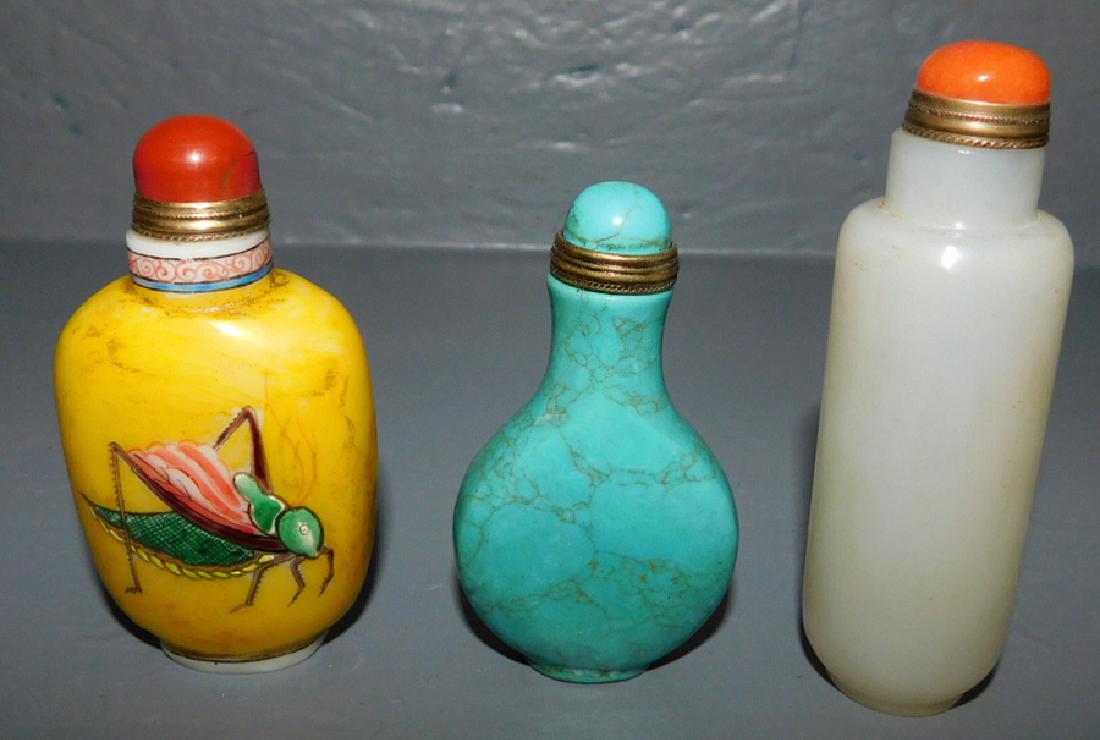 3 carved Or snuff bottles. One has cricket motif. (1 of 2)