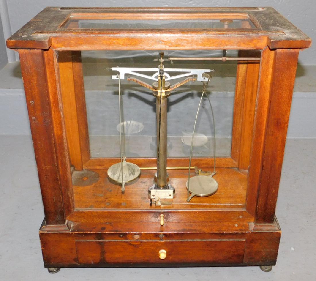 Pair of  brass scales in glass case. (1 of 4)