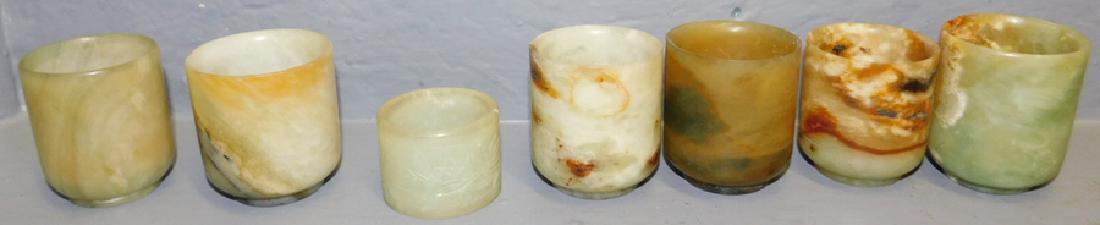 6 carved jade sake cups and napkin ring: 6 carved jade sake cups and napkin ring. To 2 1/4" tall.