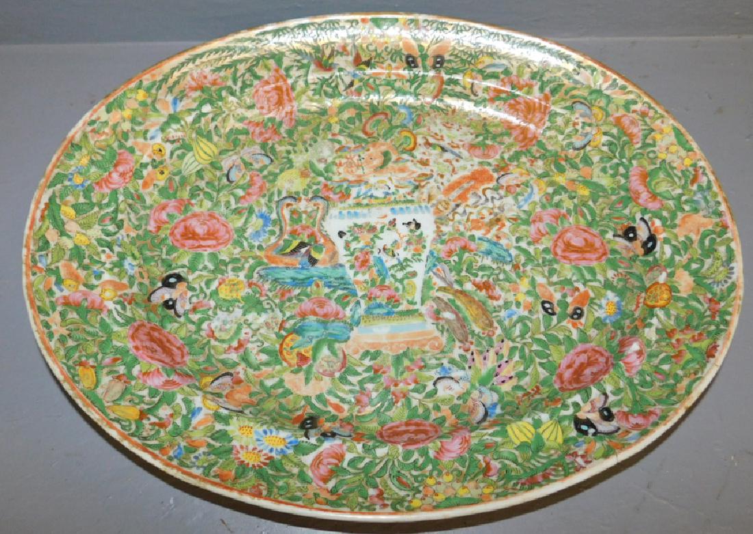 18th C Famille Rose platter: 18th C Famille Rose platter with staple repair. 18" long x 14 1/2" wide.