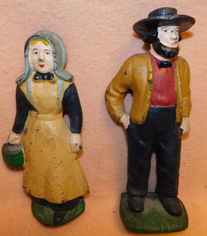Two Cast Iron Amish Door Stops: Two Cast Iron Amish Door Stops. 8 3/4" H (Man)