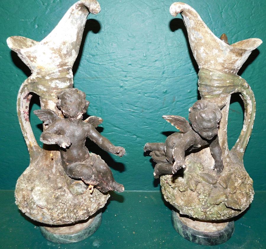 Two Metal Urns On Marble Bases W/ Cupid Details (1 of 2)