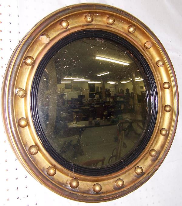 19th century gold leaf decorated bulls' eye mirror: 19th century gold leaf decorated bulls' eye mirror. 22 1/2" diameter.