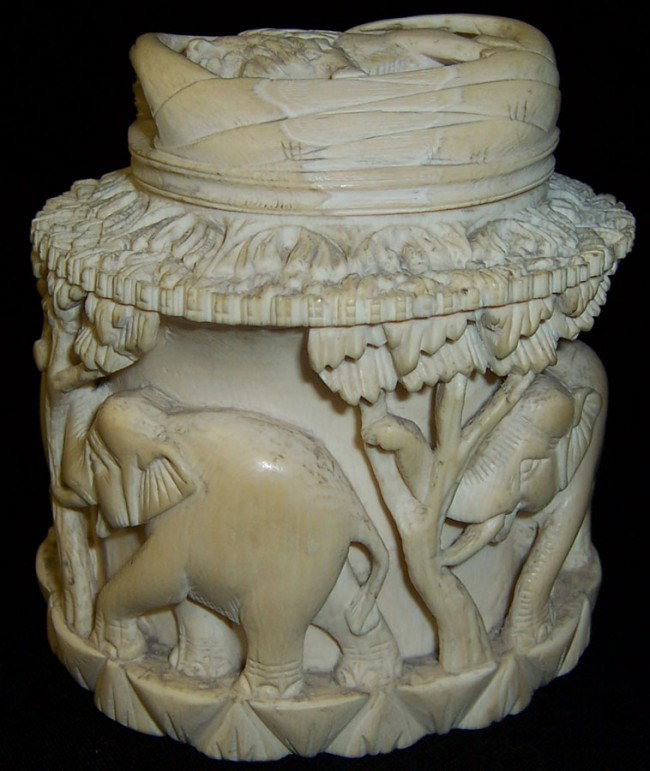 Carved ivory covered box w/ elephant & lion motif: Carved ivory covered box with elephant and lion motif.4 1/2" tall.