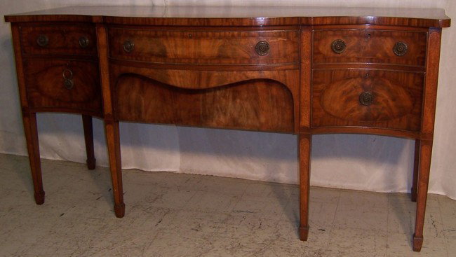Mahogany Hepplewhite sideboard: Mahogany serpentine front banded top Hepplewhite side board signed Waring and Gillow. 71" long x 26" deep x 35 1/2" tall.