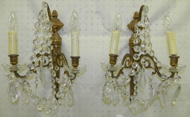 Pair of brass and crystal wall sconces.: Pair of brass and crystal wall sconces.