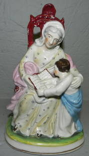 19th century Staffordshire figurine: 19th century Staffordshire figurine of elderly lady and child. 8" tall.