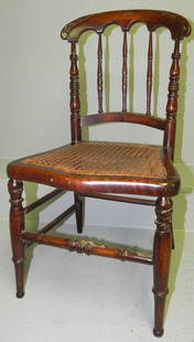 Child's Victorian cane seat chair.: Child's Victorian cane seat chair. 25 1/4" tall x 13 1/2" wide.