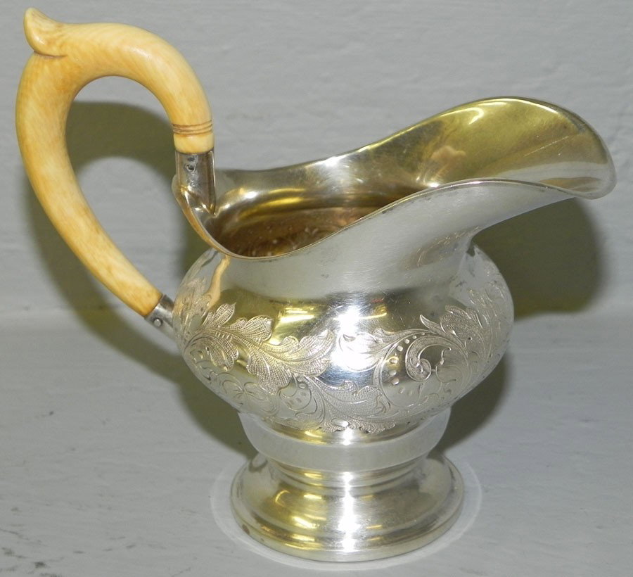 British Colonial sterling pitcher w/ ivory handle: British Colonial sterling cream pitcher with ivory handle. 5 1/2" tall. 3.28 troy oz. with handle.