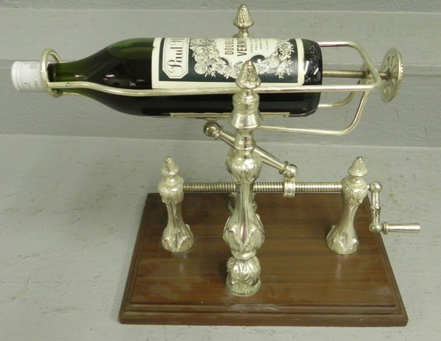 Silver plate wine holder.: Silver plate wine holder.