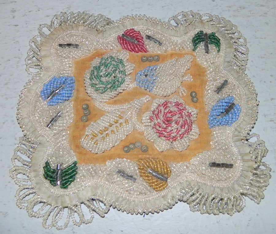 Intricate beadwork doily.: Intricate beadwork doily.