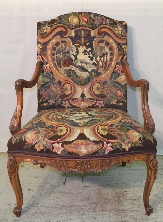 Fantastic carved French needlepoint arm chair.: Fantastic carved French needlepoint arm chair.