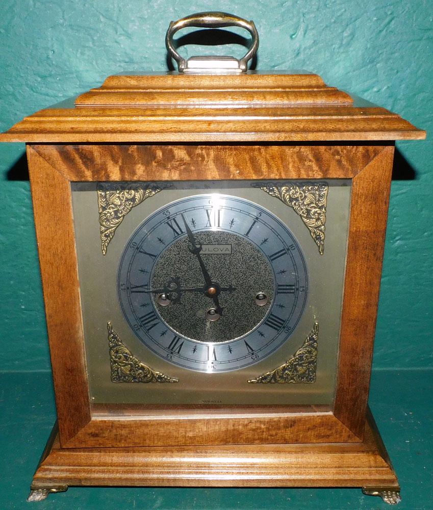 Walnut Mantel Clock By Bulova: Walnut Mantel Clock By Bulova. 12 1/2" W 15" H "ALL DESCRIPTIONS AND ANY CONDITION STATEMENT GIVEN BY LANGSTON AUCTION GALLERY ARE STRICTLY OPINIONS AND LANGSTON'S SHALL HAVE NO RESPONSIBILITY FOR ERR