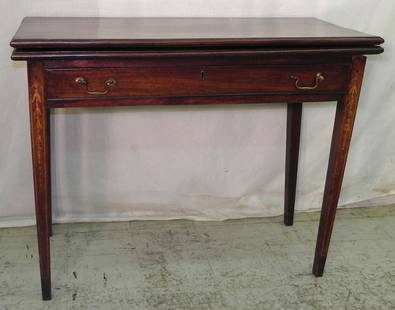 19th century fold over Hepplewhite game table: 19th century fold over Hepplewhite game table with bellflower inlay. 39 1/2" long x 17 1/2" closed x 30 1/2" tall.
