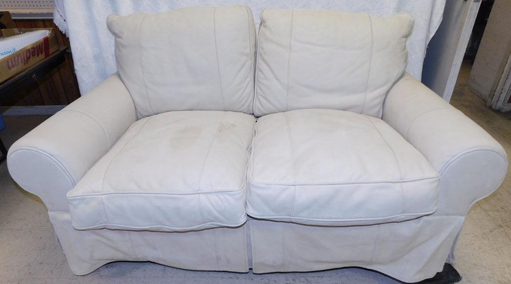 Leather Upholstered Love Seat: Leather Upholstered Love Seat. 64" W 38" W 34" H "ALL DESCRIPTIONS AND ANY CONDITION STATEMENT GIVEN BY LANGSTON AUCTION GALLERY ARE STRICTLY OPINIONS AND LANGSTON'S SHALL HAVE NO RESPONSIBILITY FOR E