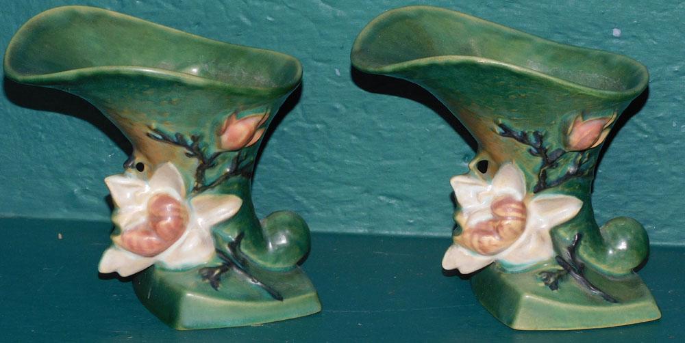Pair of Roseville Magnolia Cornucopias: Pair of Roseville Magnolia Cornucopias . 6 1/4" H ALL DESCRIPTIONS AND ANY CONDITION STATEMENT GIVEN BY LANGSTON AUCTION GALLERY ARE STRICTLY OPINIONS AND LANGSTON'S SHALL HAVE NO RESPONSIBILITY FOR E