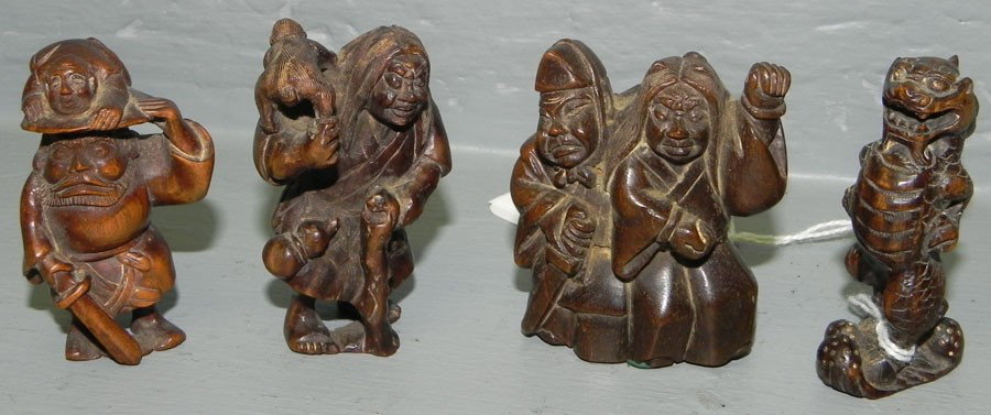 4 carved wooden netsukes.: (4) carved wooden netsukes.