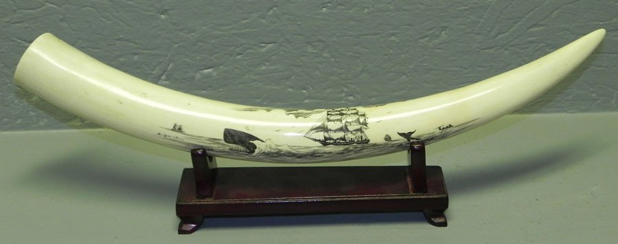 Scrimshaw ivory or bone tusk. Signed: Scrimshaw ivory or bone tusk. 17" long with stand. Signed An Yue Shan.