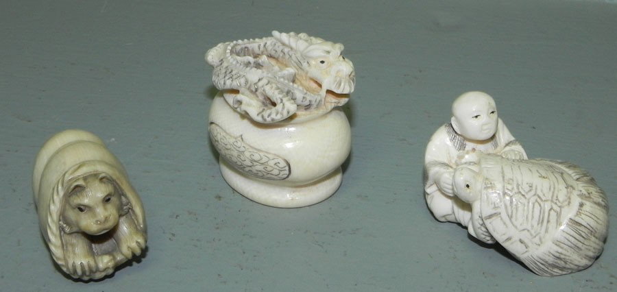3 ivory or bone netsukes.: (3) ivory or bone netsukes. Dragon on pedestal, turtle with boy and cat with shell. Approx. 1 1/4" long