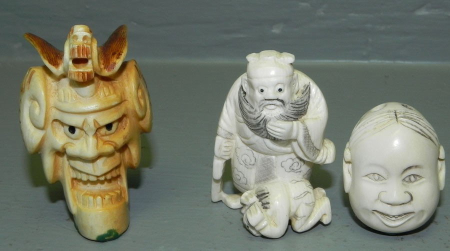 3 ivory or bone netsukes.: (3) ivory or bone netsukes. Double face, mask and old man with paddle. 1 1/2" to 2".