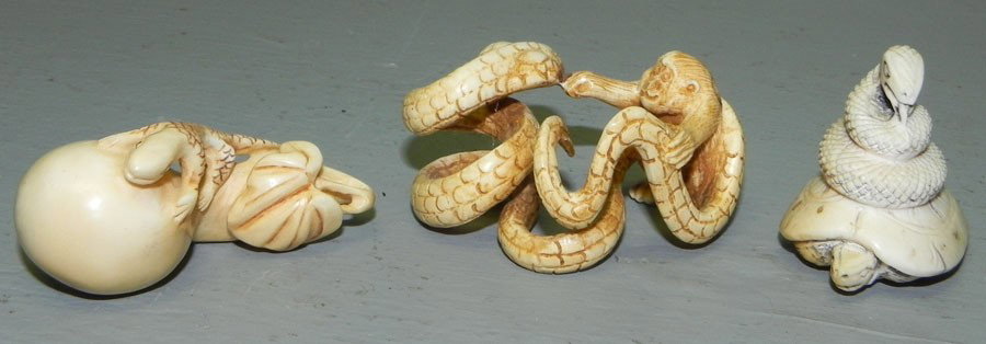 3 carved ivory netsukes: (3) carved ivory netsukes, 2 are snakes and 1 is a salamander.1 1/2" to 2 1/4".