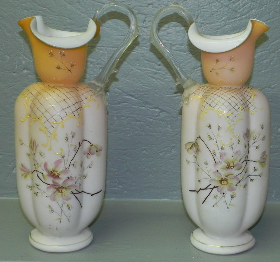 Pair of hand painted satin glass pitchers. Signed: Pair of hand painted satin glass pitchers. Signed Thomas Webb & Sons. 12 1/4" tall.