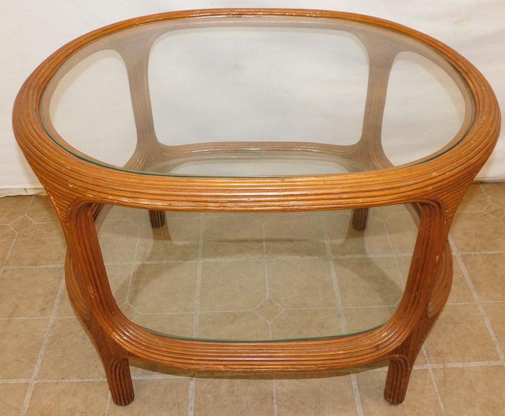 2 Tier Ratan Glass Top Table: 2 Tier Ratan Glass Top Table . 29" W 23" D 21 1/4" H ALL DESCRIPTIONS AND ANY CONDITION STATEMENT GIVEN BY LANGSTON AUCTION GALLERY ARE STRICTLY OPINIONS AND LANGSTON'S SHALL HAVE NO RESPONSIBILITY FO