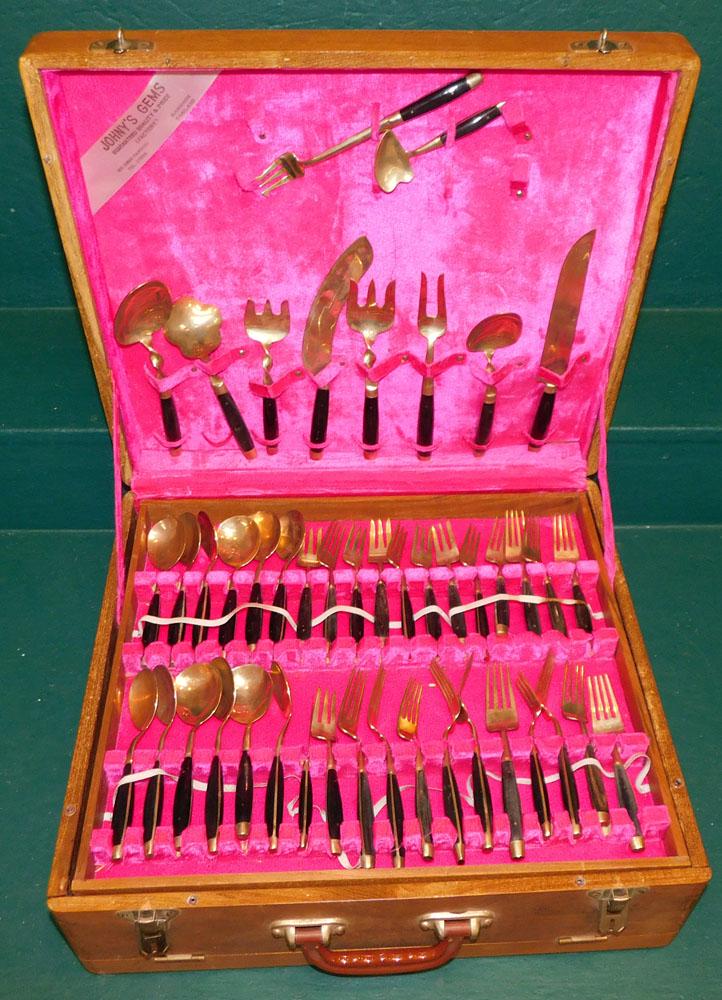 Set Brass & Ebony Handle Flatware In Case: Set Brass & Ebony Handle Flatware In Case. Case: 17" W 19" D 7" H ALL DESCRIPTIONS AND ANY CONDITION STATEMENT GIVEN BY LANGSTON AUCTION GALLERY ARE STRICTLY OPINIONS AND LANGSTON'S SHALL HAVE NO RESP